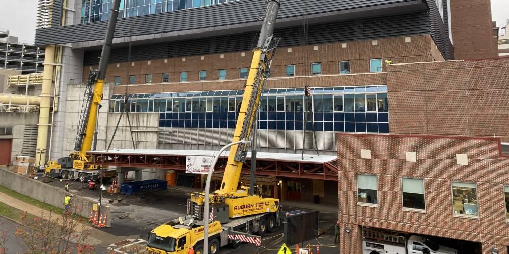 UP AWNING: A 160,000-pound steel awning is raised into place outside of Upstate University Hospital’s downtown Emergency Department entrance. The awning will keep rescue vehicles out of the rain as they off load patients into the Emergency Department.