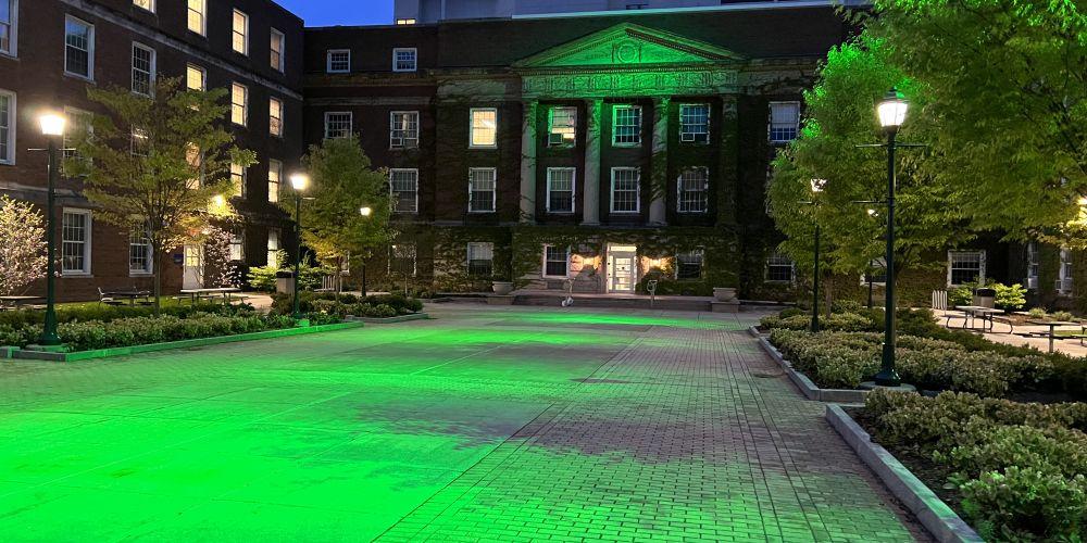 GOING GREEN: Weiskotten Hall courtyard is bathed in green in support of Lyme Disease Awareness Month.