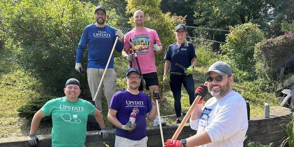 DAY OF CARING: Upstate employees taking part of the United Way of CNY’s Day of Caring Aug 3 are, from left, Robert Taylor, Matthew Capogreco, Scott Neal, Dylan Tripodi, Bobbi Jo Massena and Martin Earl. Employees participated in clearing brush at the Jowonio School and painting at Chadwick Residence. Hundreds of employees from businesses and institutions took part in community projects throughout the county.