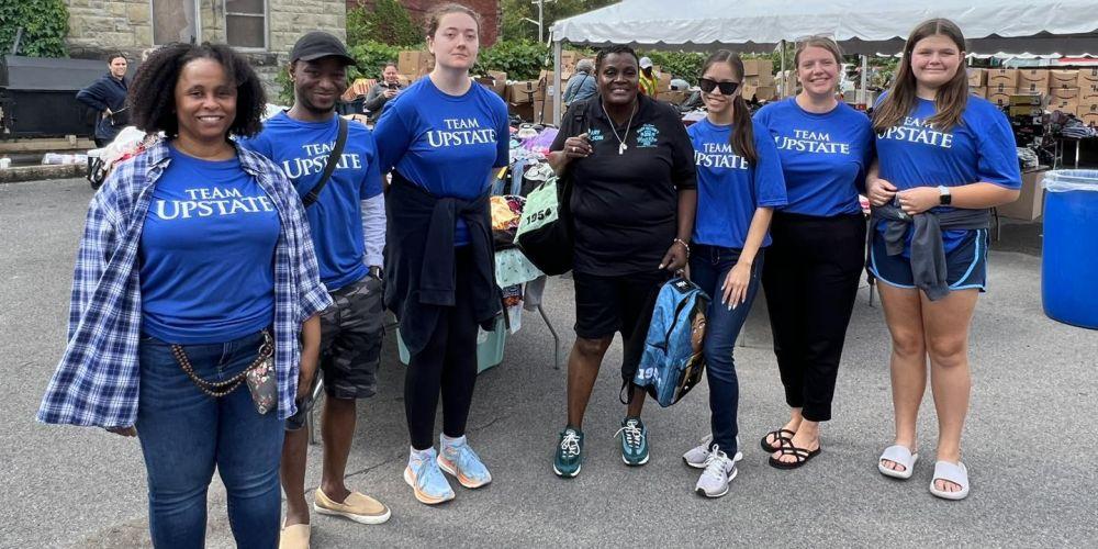 SERVING THE COMMUNITY: Upstate’s Mary Nelson, center, gets help from Upstate employees at her annual Youth Day BBQ Aug 19, which provides free backpacks, school supplies and clothing to local school kids. Nelson, who works with Upstate Radiology, is also the founder of the Mary Nelson Youth Center.