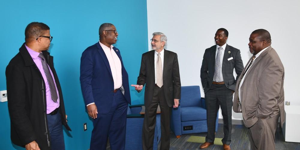 EDUCATION VIPS: Upstate President Mantosh Dewan, MD, center, chats with, from left, Sipho Mbque, PhD, Upstate professor of diversity and inclusion; Onondaga Community College President Warren Hilton, PhD; Executive Director of Say Yes to Education Syracuse Ahmeed Turner and  Syracuse City School Superintendent Anthony Davis, who participated in a panel presentation on Student Success and Academic Excellence, as part of Upstate’s Black History Month activities.