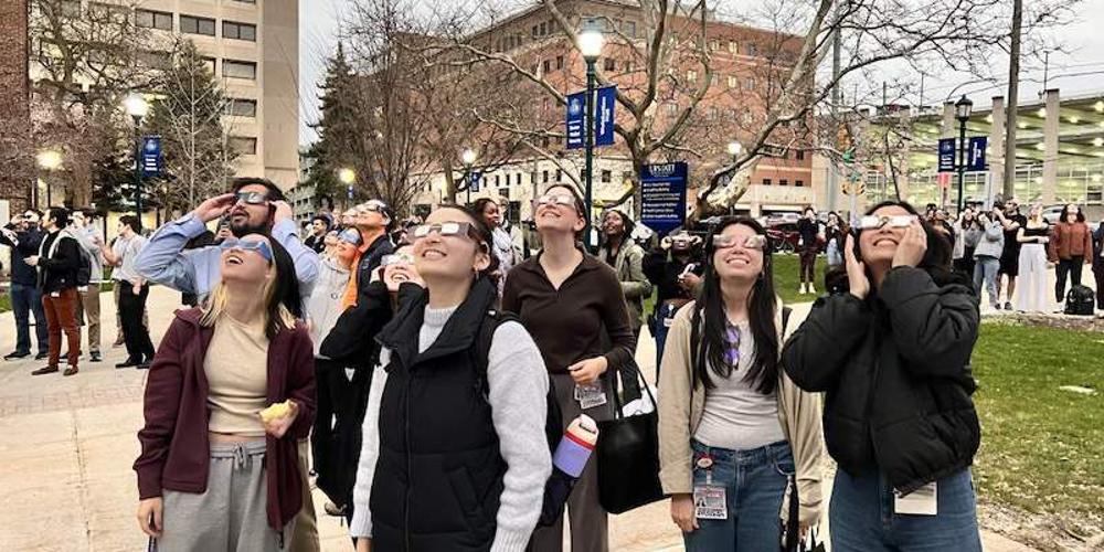 TOTAL ECLIPSE: Upstate students and staff gathered in Weiskotten Hall courtyard to view the solar eclipse, as day turned to night, illuminating the campus lights.