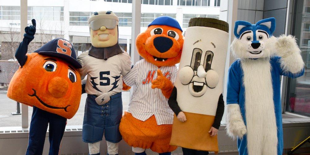 WITH A LITTLE HELP FROM MY FRIENDS: Area mascots—from Syracuse University, the Syracuse Crunch and the Syracuse Mets—showed up in force April 19 for a campus clean in advance of Earth Day. The group gathered in the Upstate Cancer Center before heading out to clean up campus. From left, are Otto the Orange, Crunchman, Scooch, Mr Butts and Hero from Upstate Medical.