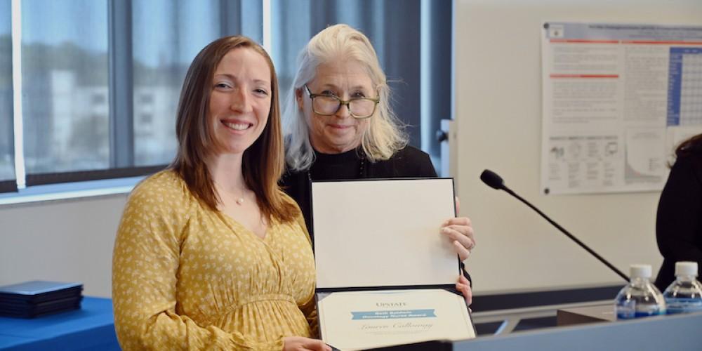 AWARD WINNER: Lauren Calloway, BSN, RN, ONC, an oncology nurse at Upstate, left, receives the Beth Baldwin Oncology Nurse award during the Upstate Cancer Center retreat April 26. The award, presented by Baldwin, right, is awarded to the oncology nurse who represents excellence in care and passion for cancer patients. The award is named for Baldwin, the executive director of the Carol Baldwin Breast Cancer Research Fund, which has raised more than $4 million to fund breast cancer research at Upstate.