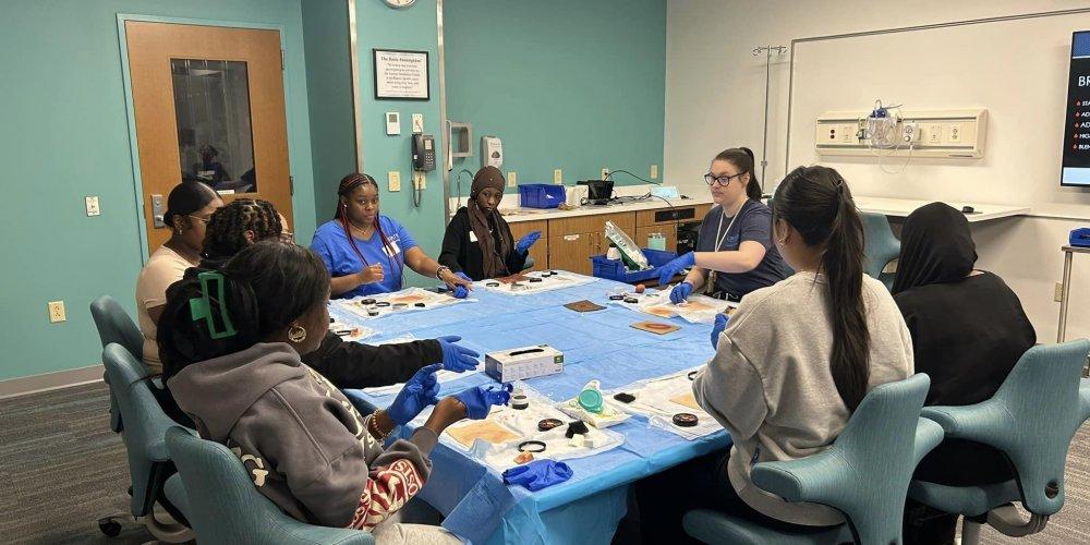 SIM CENTER VISIT: Henninger High School students visit Upstate’s Simulation Center to learn about jobs in health care simulation. The students took part in three programs, Stop the Bleed, Moulage Magic and Immersive Simulation. The May 8 visit was sponsored by Manufacturers Association of Central New York.