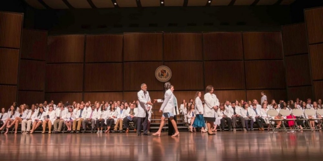 WHITE COAT TIME: More than 340 students in the Norton College of Medicine and the College of Health Professions received a handshake from Upstate President Dr. Mantosh Dewan and their white coats, a symbol of beginning their education in the medical field during the traditional White Coat ceremony.
