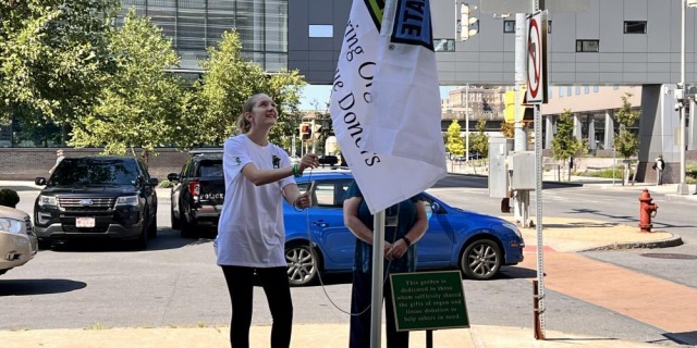 DONATE LIFE: Brianna George raises the Donate Life flag outside Upstate University Hospital in memory of her late brother Lucas, who he died July 12. Lucas’s organs were donated to save the lives of others. The Upstate Donor Council holds flag-raising ceremonies throughout the year to honor organ donors and their families.