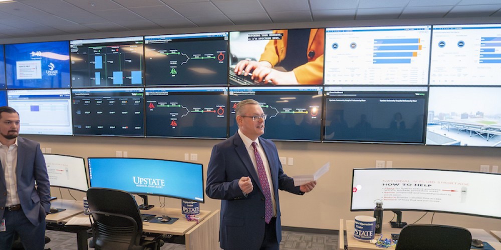 MISSION CONTROL: Chief Nursing Officer Scott Jessie speaks at the opening of Upstate’s new Throughput Operations Center. The center is chock-full of technology with 22 live feed monitors and 28 computer stations offering hospital officials a real-time view of operations in all areas of the health system.