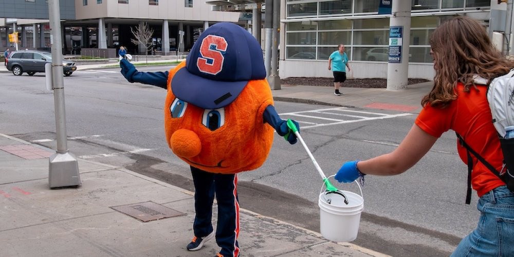 EARTH DAY CLEAN UP: Famous local mascot Otto takes part in Upstate’s Earth Day clean up as the SU orange joined staffers cleaning up litter from around campus. Joining Otto was the Scooch from the Syracuse Mets.