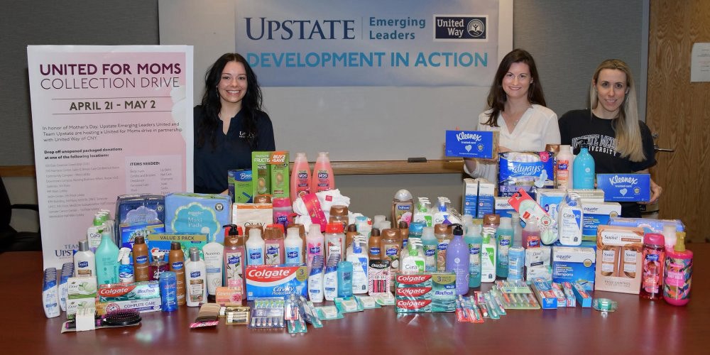 UNITED FOR MOMS: Emerging Leaders United Upstate chapter members, from left Tara Pinkerton, Sarah Trapani and Veronica Farrell, with goods collected for the United for Moms drive, conducted in partnership with the United Way of Central New York. Upstate employees dropped off toiletries at collection boxes throughout Upstate that filled more than 200 gift bags distributed by various agencies, including Chadwick Residence, Vera House, Huntington Family Centers and others.
