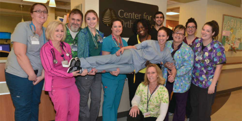 A group of nurses smiling and posing for photo