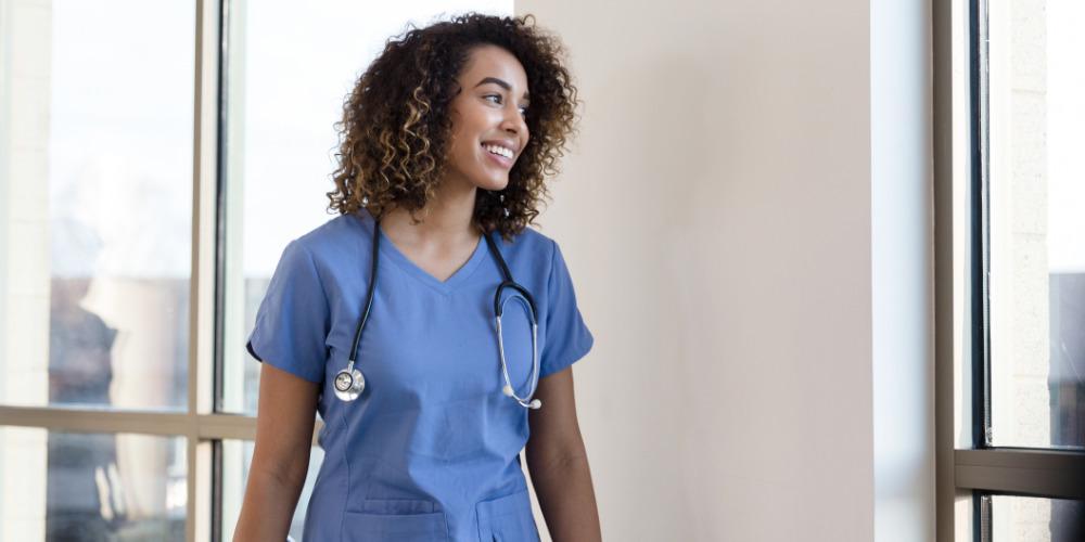 Smiling happy nurse in hallway
