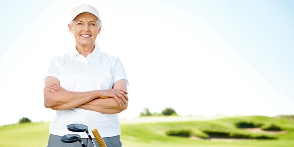 Senior woman smiling at golf resort