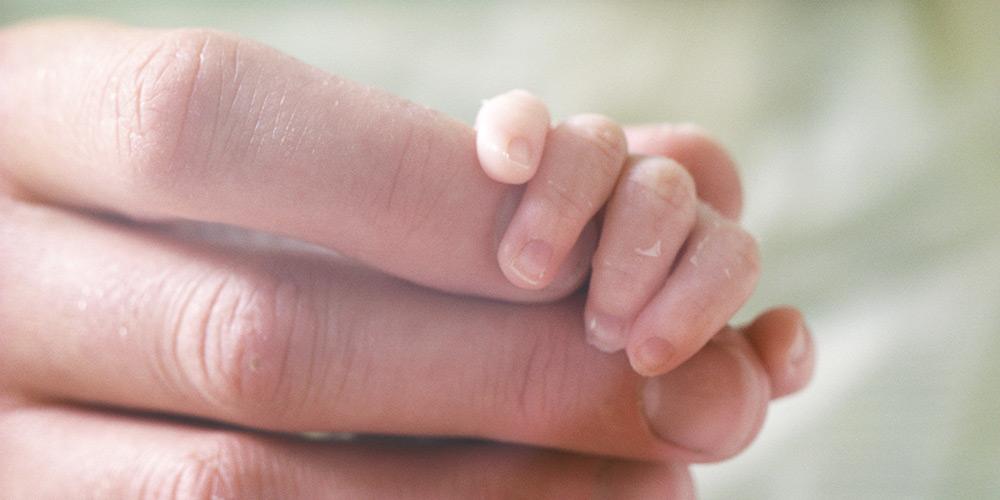Baby hand inside mothers hand
