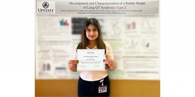 Veronica in front of her award winning poster