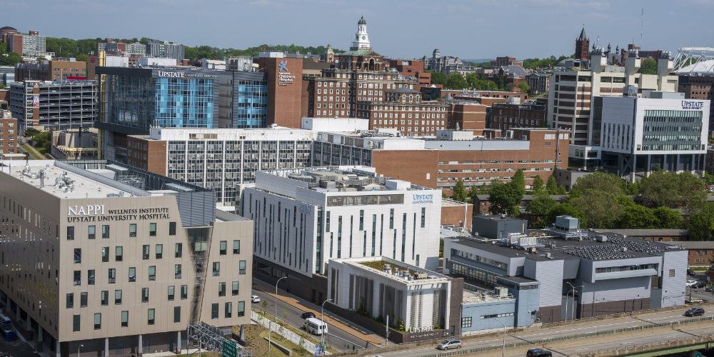 Outside photo of many Upstate buildings along the Syracuse skyline