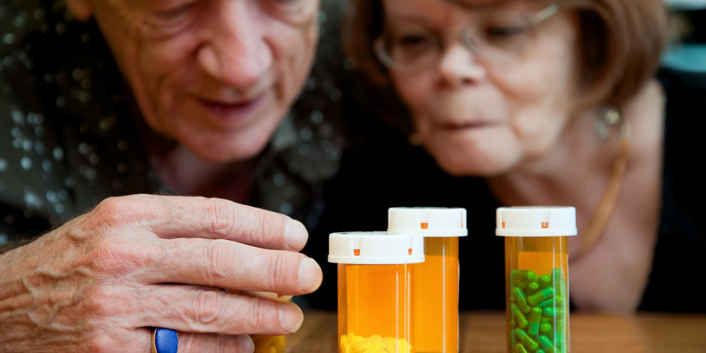 Older couple looking at their medicines