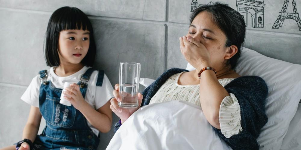 Woman taking pill with granddaughter