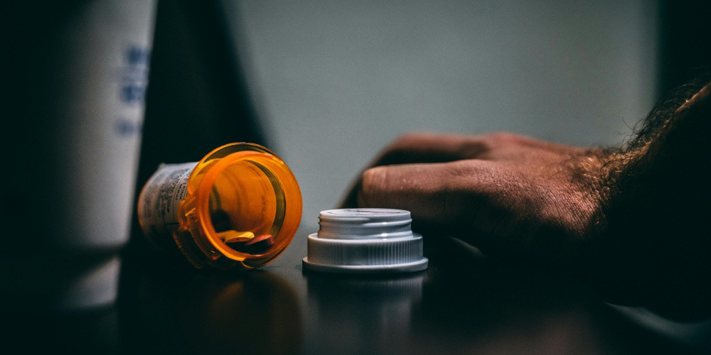 image of a pill bottle open on a table
