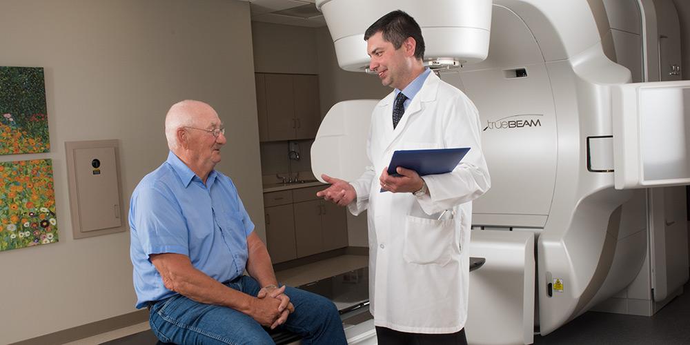 Doctor and patient in front of true beam radiation machine
