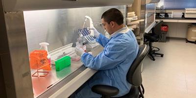 Man in VBL lab doing tests