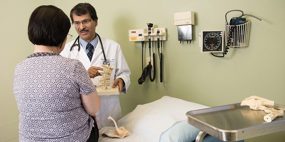 Doctor showing patient spine example