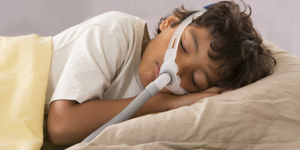 Child sleeping with PAP mask on.