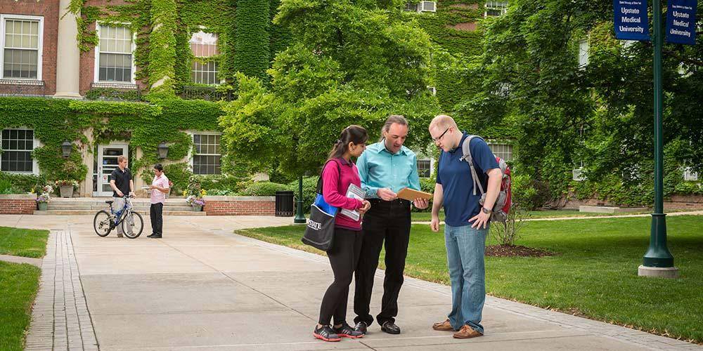 Wilkens with students in front of Wsk Hall