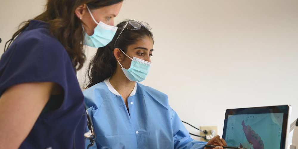 Dr. DiFlorio and resident looking at a touch screen