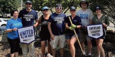 Emerging Leaders report cover featuring participants doing cleanup work