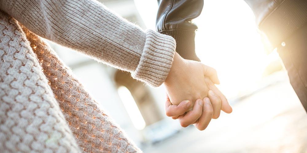 Couple holding hands and walking