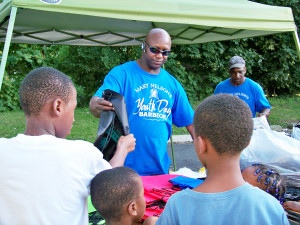 Volunteer distributes backpacks