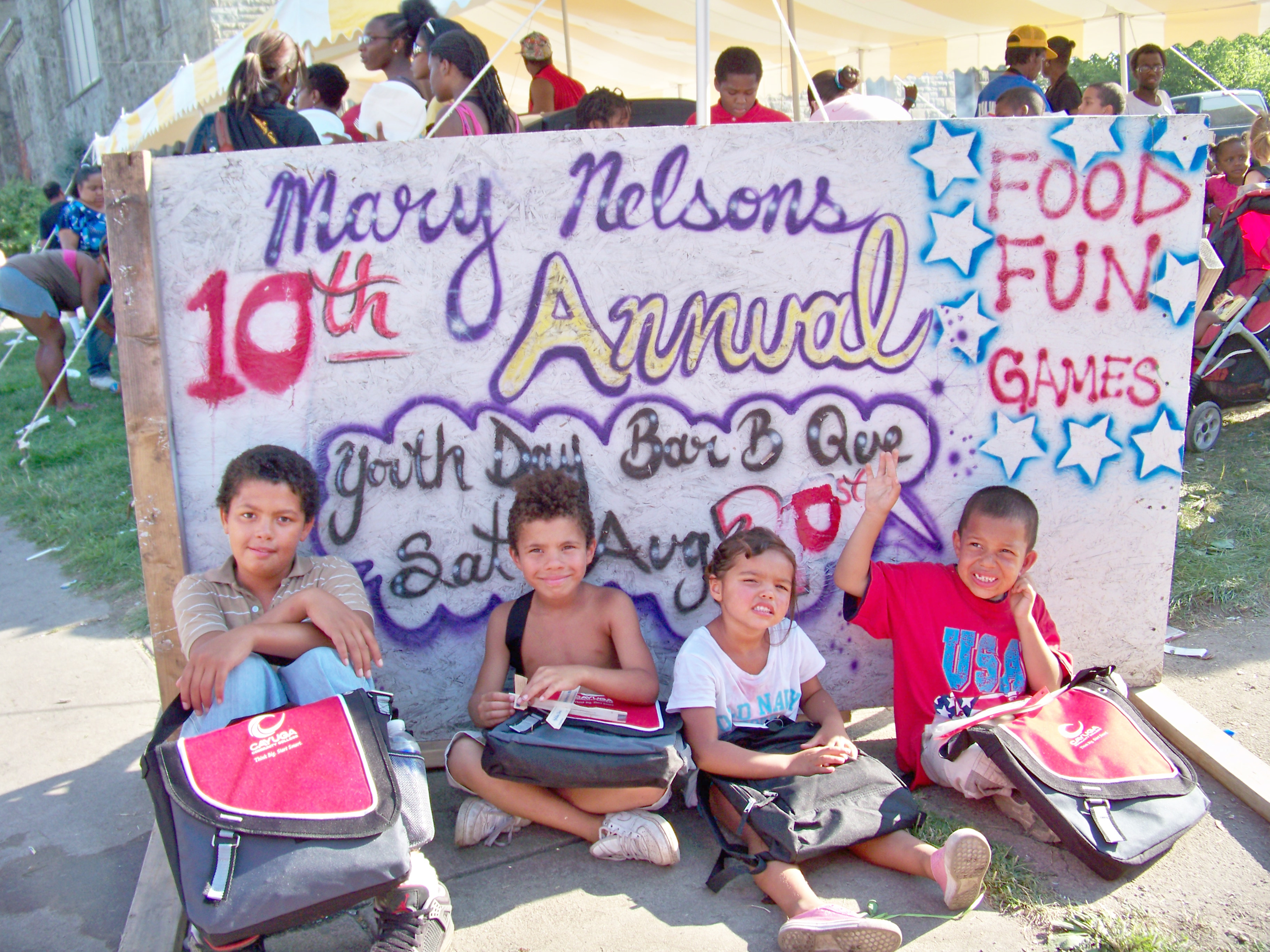 four children with backpacks