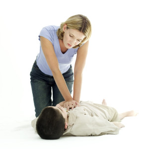 Woman Resuscitating a Young Boy
