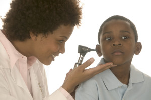 Healthcare worker looking in child's ear