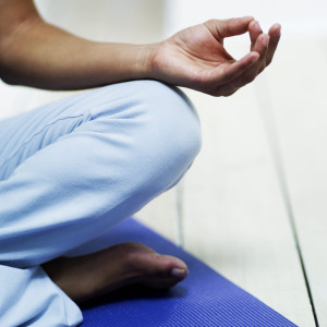 Young Woman Meditating on the Floor Young Woman Meditating on the Floor