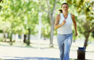 portrait of a mid adult woman jogging in a park portrait of a mid adult woman jogging in a park