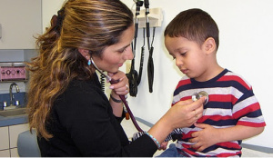 ahc Healthcare worker listening to child's heartbeat