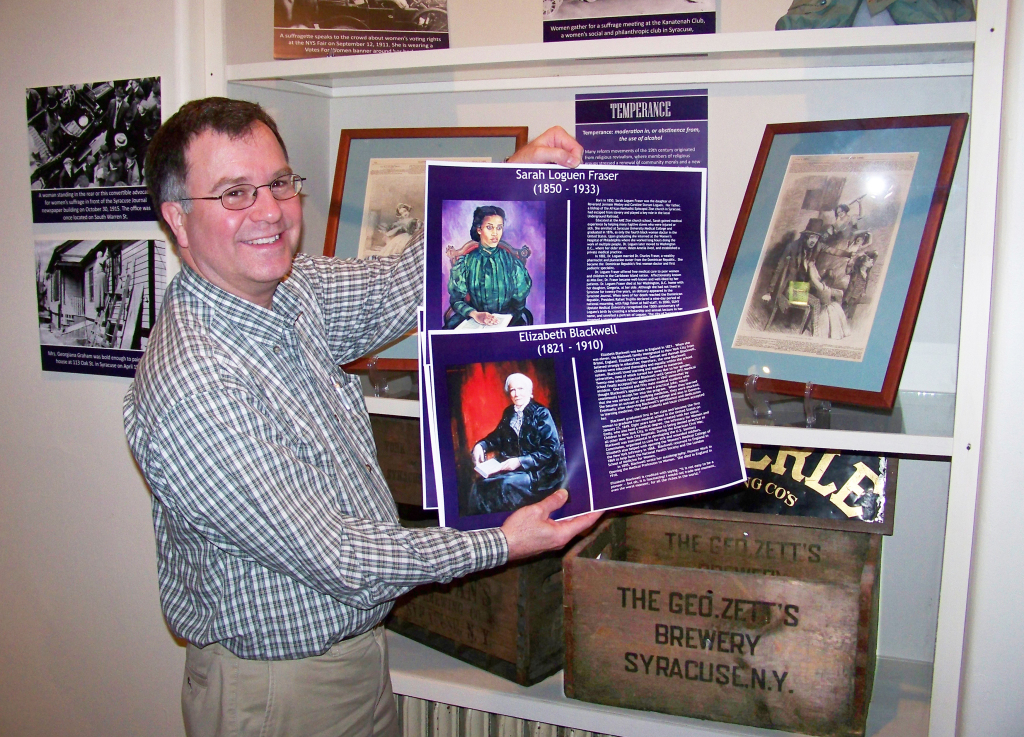 Man showing posters of two doctors