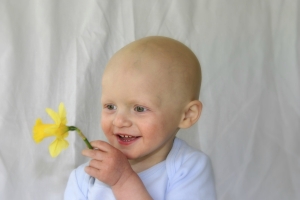Bald child with flower
