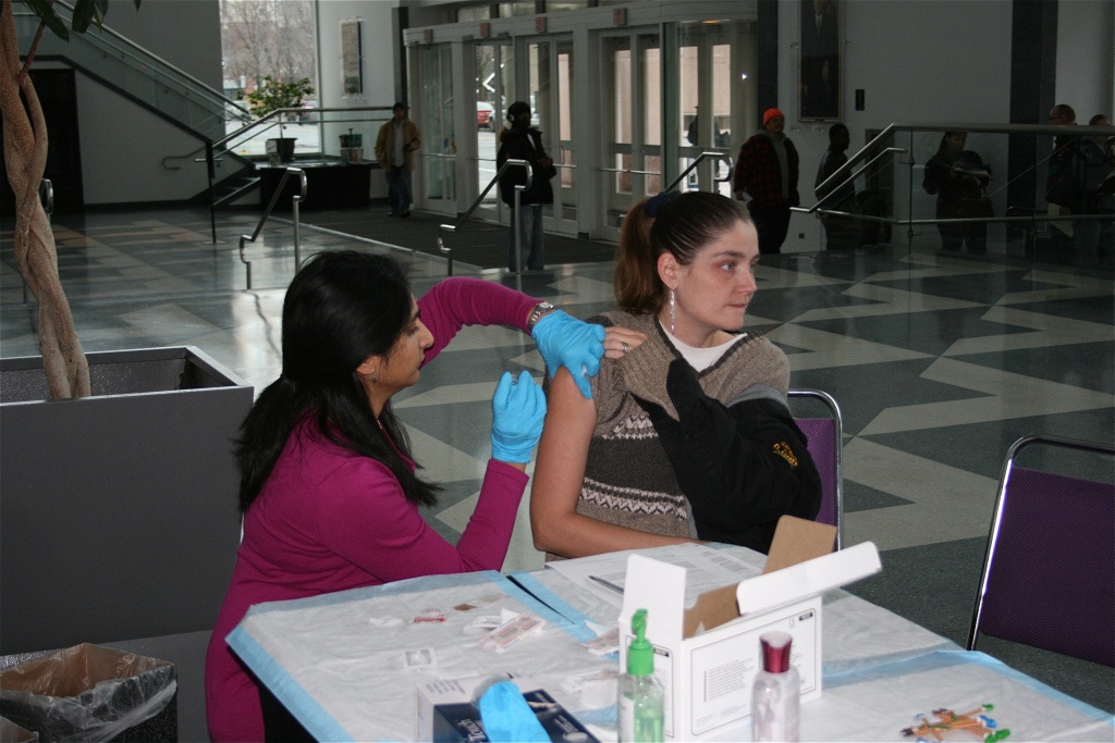 Dr. Manika Suryadevara gives a flu shot. Photo by Kathleen Paice.