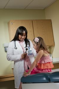 Olamide Ajagbe MD takes care of Mia, 5, who was at Upstate Golisano After Hours Care because her ear hurted. Photo by Robert Mescavage.
