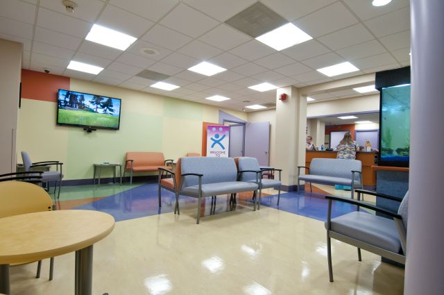 The center is open evenings and weekends. Its colorful furnishings are based on the Upstate Golisano Children‘s Hospital. There are lots of comfortable chairs, and a big TV, a fish tank and fun-house style mirrors that provide entertainment. Photo by Robert Mescavage.