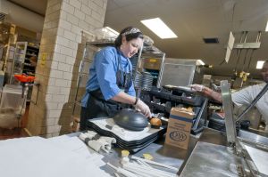 Karoline Simpson prepares food trays for patients.