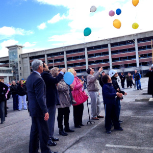 Participants release balloons during the ceremony. Photo by Darcy DiBiase.