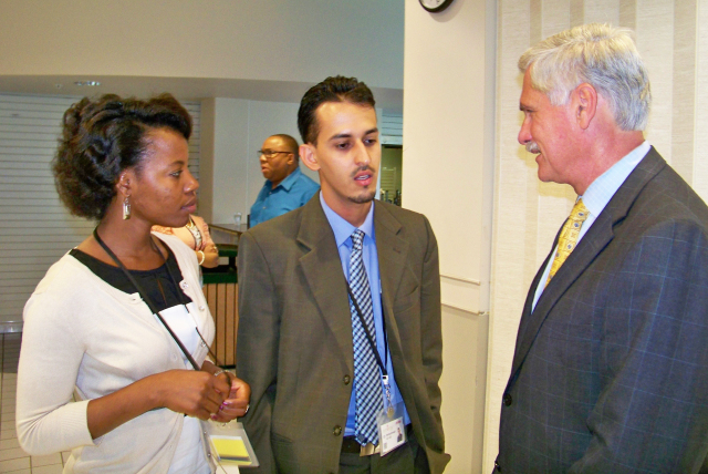 Interns Frances Day and Mohammad Al-Ali talk with Upstate president Dr. David R. Smith, MD at the welcome luncheon for the summer 2013 Synergy/Mercy Works summer internship program.