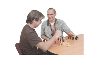To stimulate short-term memory, Paul Dunning, right, plays chess with Merrill Cline, 49, in Upstate's rehabilitation unit. Two weeks earlier, Cline was airlifted to the Upstate Stroke Center after dizziness and headache proved to be a stroke.