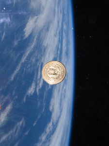 The medallion floats inside the International Space Station during its 146-day stay.