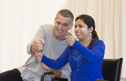 Syracuse University professor Stephen Cross works with first-year medical resident Dipti Baral, MD during a class this fall at Syracuse Stage.