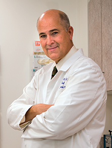 Dr. David Halleran in his office at Colon Rectal Associates of Central New York. Photo by Bob Mescavage.